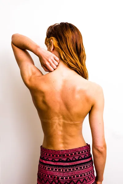 Young woman touching her sunburned neck — Stock Photo, Image