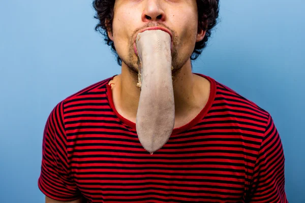 Man met een koemelk tong in zijn mond — Stockfoto