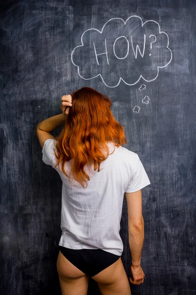 Ditzy redhead woman asking how — Stock Photo, Image