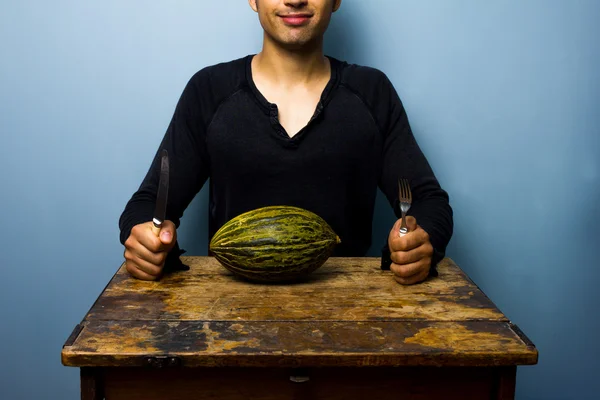 Jovem saudável tendo um melão para o jantar — Fotografia de Stock