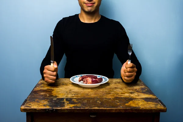 Young man having a heart for lunch — Stock Photo, Image