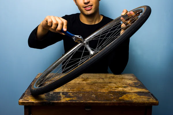 Worker fixing bicycle tyre — Stock Photo, Image