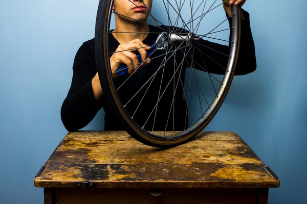 Worker fixing bicycle tyre — Stock Photo, Image