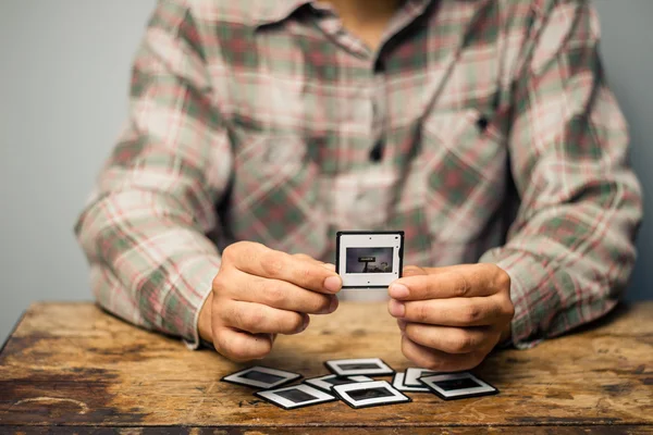 Man looking at his old slides — Stock Photo, Image