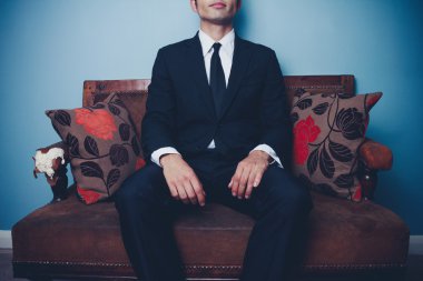 Businessman relaxing on sofa