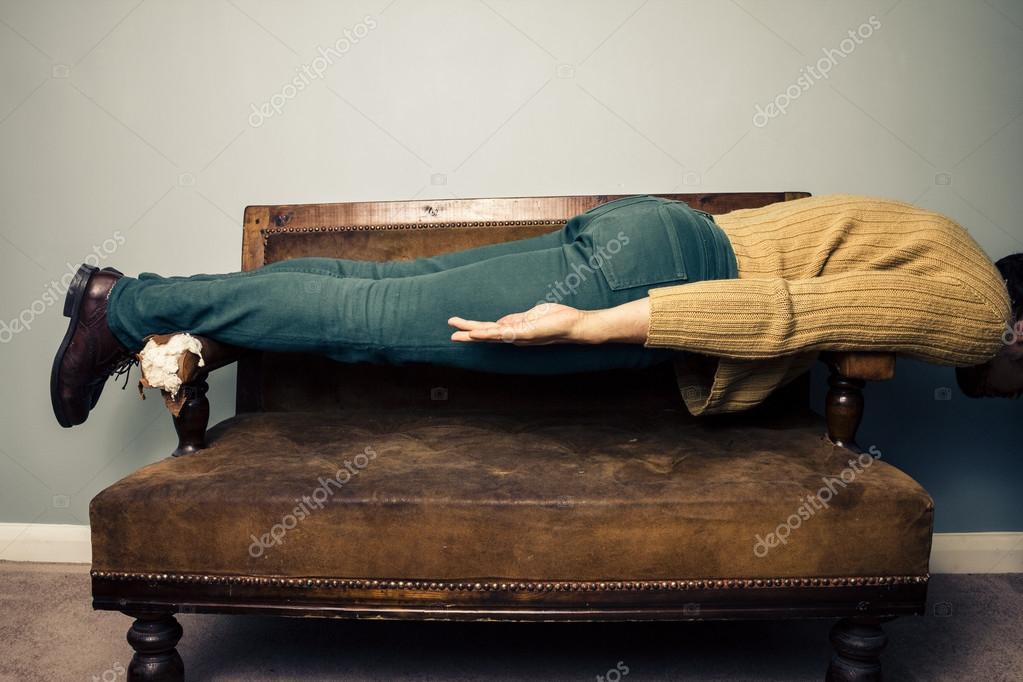 Young man in plank position on old sofa Stock Photo by ©lofilolo 30952895