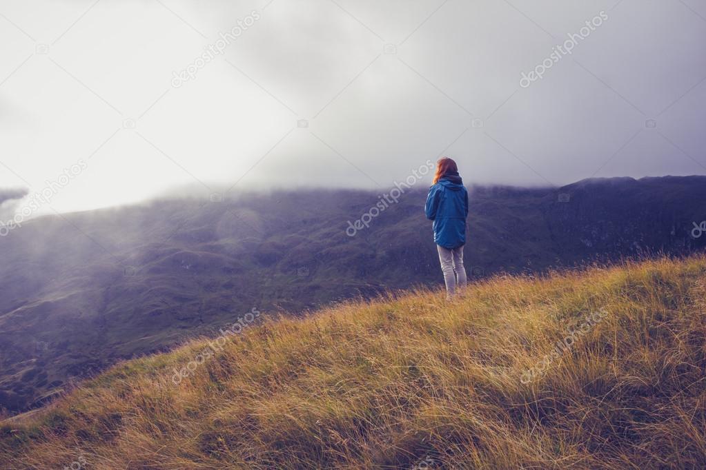 Woman admiring sunset from mountain top