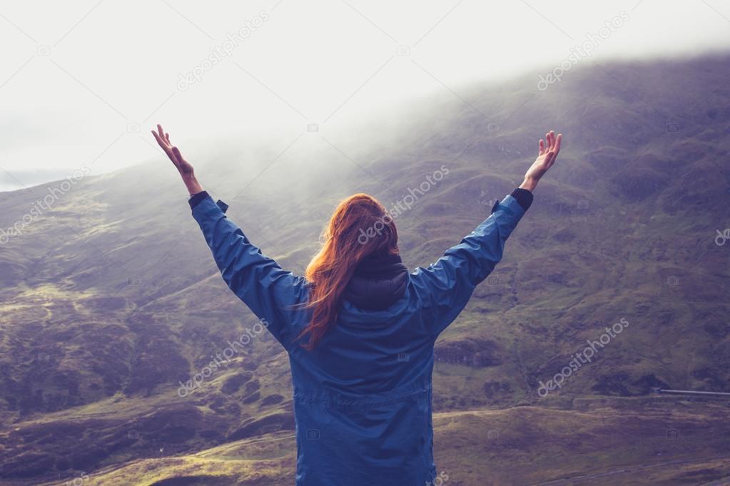 Woman expressing freedom on mountain
