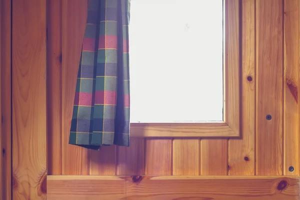 Looking out through window in wooden door — Stock Photo, Image