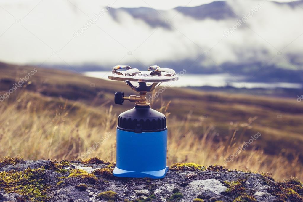 Camping stove on a rock in the mountains