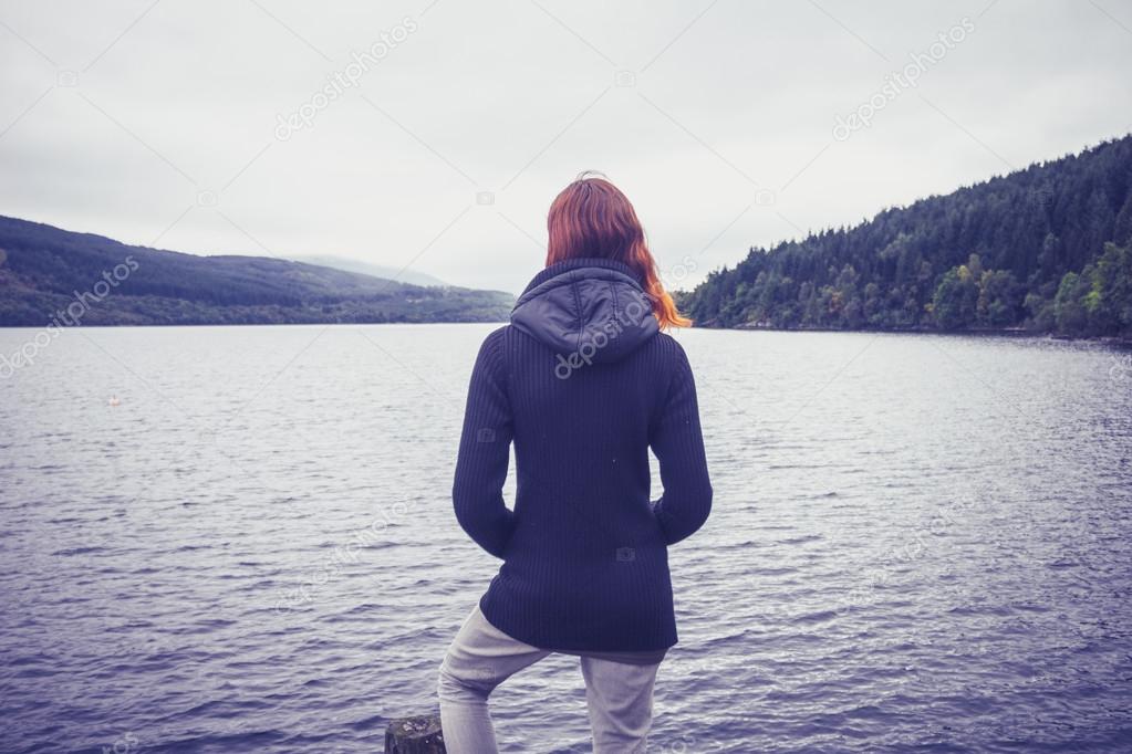 Woman admiring stillness of the lake