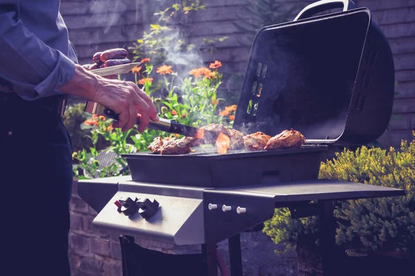 Man cooking meat on barbecue — Stock Photo, Image