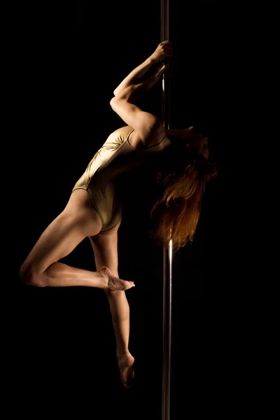 Sexy young female pole dancer on black background — Stock Photo, Image