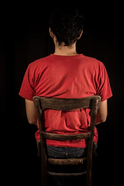Young man sitting on old chair — Stock Photo, Image