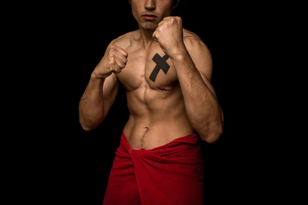 Young athletic shirtless man posing on black background — Stock Photo, Image