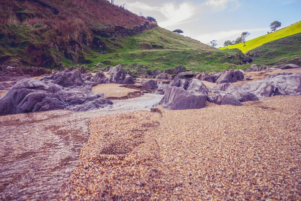 Rocky cliffs on beach — Stock Photo, Image
