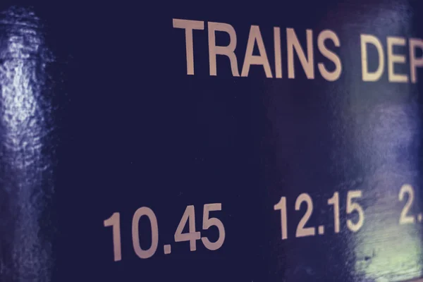 Train times on wooden board — Stock Photo, Image