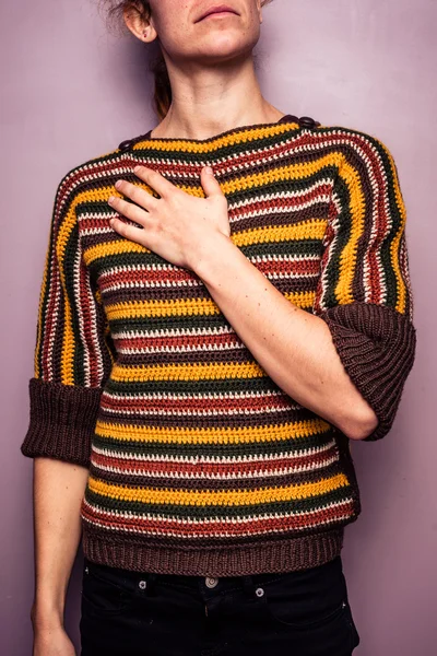 Young woman touching her chest — Stock Photo, Image