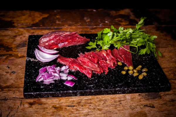 Doğrama kurulu üzerinde steak tartare malzemeler — Stok fotoğraf
