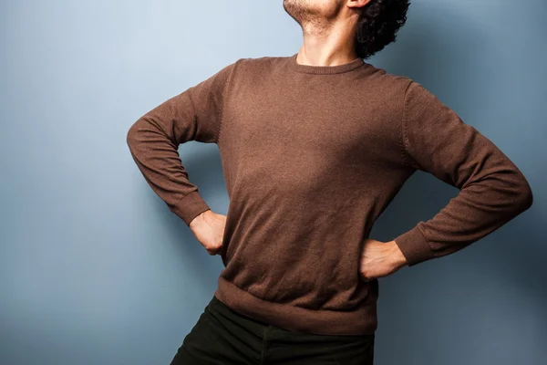 Young man is standing in a proud stance — Stock Photo, Image