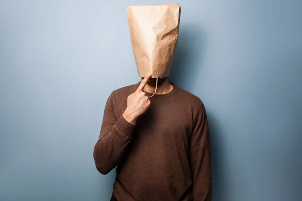 Stupid young man with bag over his head — Stock Photo, Image