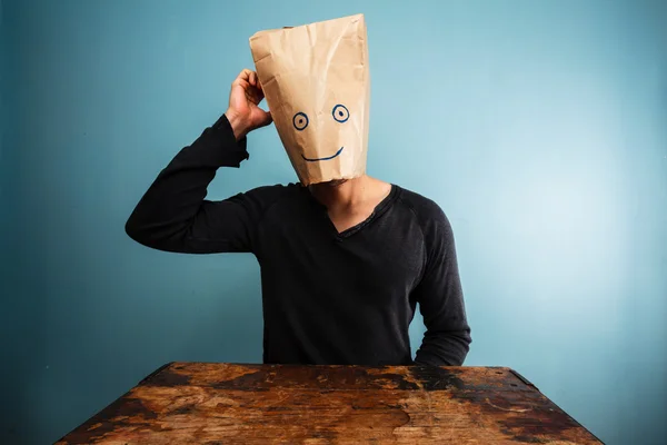 Confused man with bag over his head — Stock Photo, Image