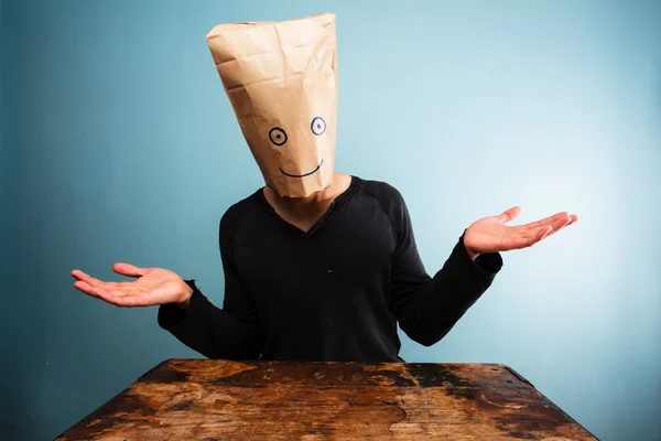 Confused man with bag over head — Stock Photo, Image