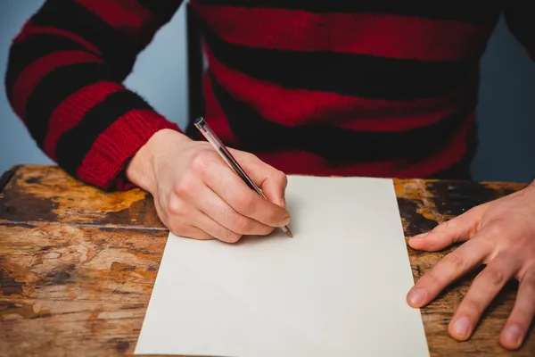 Young man is writing a letter — Stock Photo, Image
