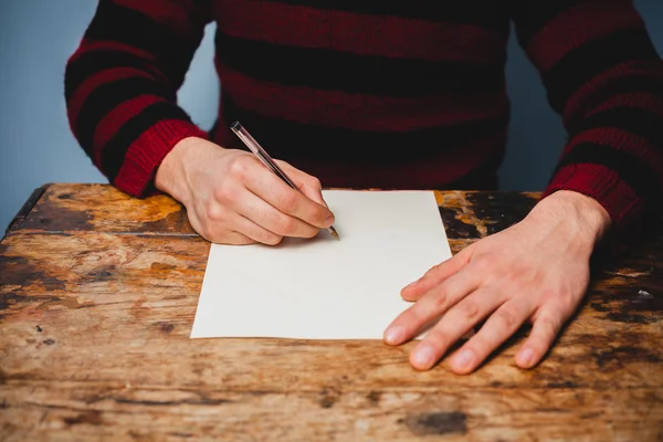 Young man is writing a letter — Stock Photo, Image