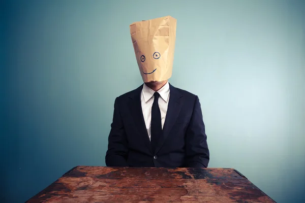 Businessman with bag over head — Stock Photo, Image