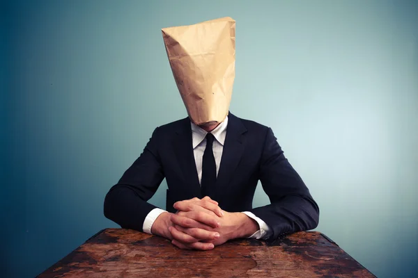 Relaxed businessman with bag over head — Stock Photo, Image