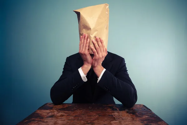 Upset businessman with bag over his head — Stock Photo, Image