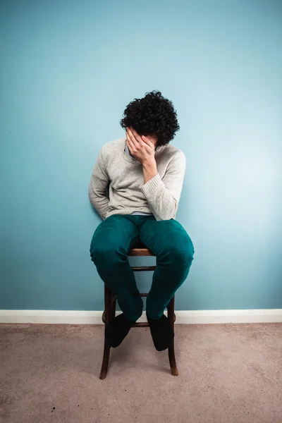 Verdrietig man zit op een stoel — Stockfoto