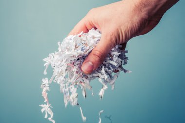Hand with shredded paper clipart