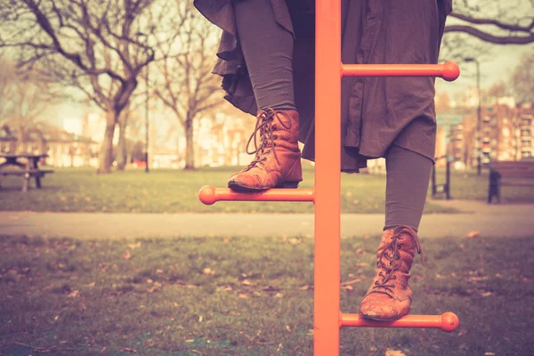 Vrouw klimmen op speelplaats — Stockfoto
