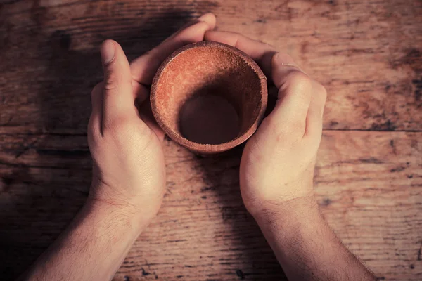 Hands holding leather dice cup — Stock Photo, Image