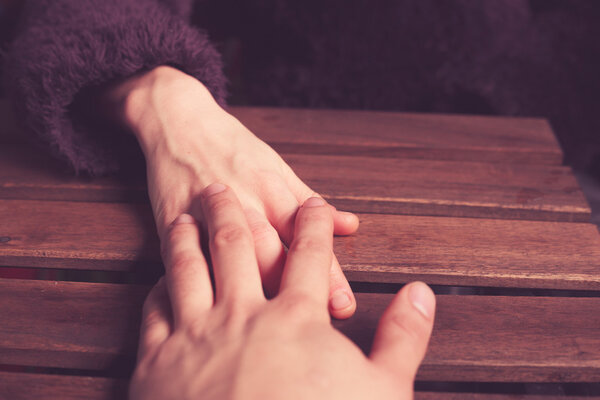 Couple's hands at table