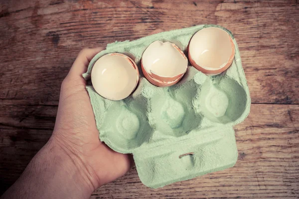 Mão segurando uma bandeja de cascas de ovo — Fotografia de Stock
