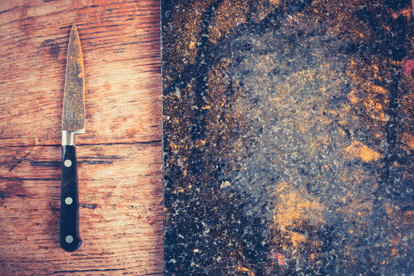 Knife and chopping board covered in spices