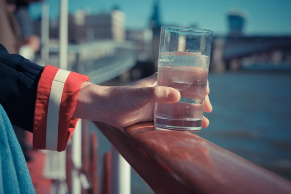 Relaxing with drink of water on a boat — Stock Photo, Image