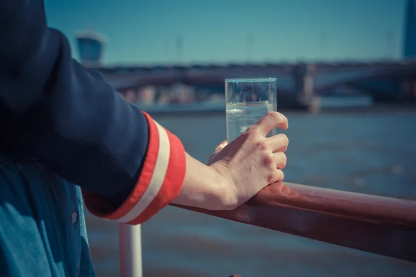 Relaxing with drink of water on a boat — Stock Photo, Image