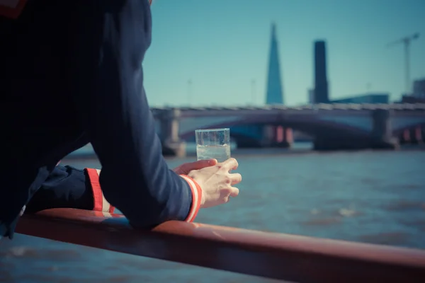 Relaxing with drink of water on a boat — Stock Photo, Image