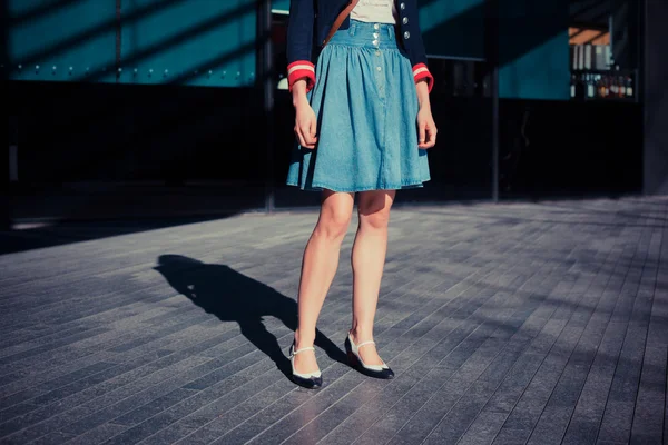 Young woman in skirt standing in the street — Stock Photo, Image