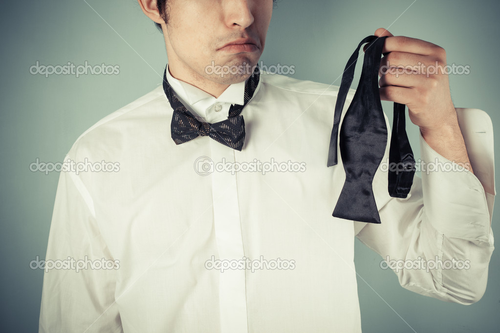 Young man ding a bow tie