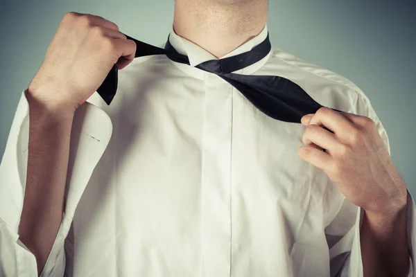 Young man tying a bow tie — Stock Photo, Image