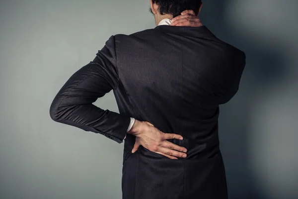 Businessman with sore back and neck — Stock Photo, Image