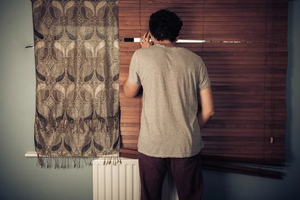 Peeping tom looking through blinds — Stock Photo, Image