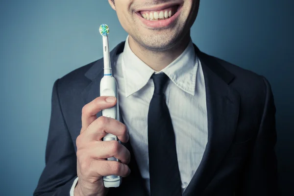 Businessman brushing his teeth — Stock Photo, Image