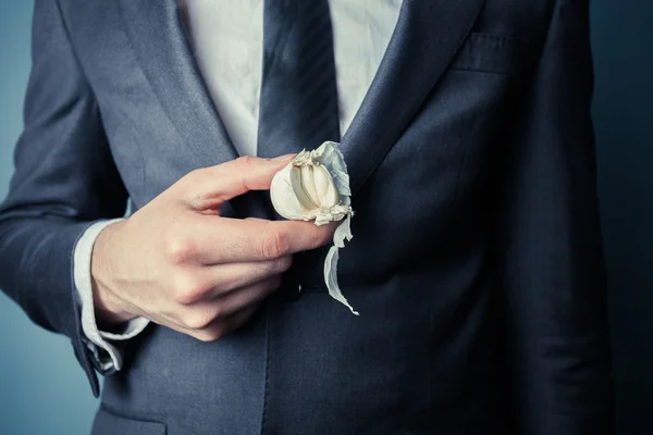 Businessman with garlic — Stock Photo, Image