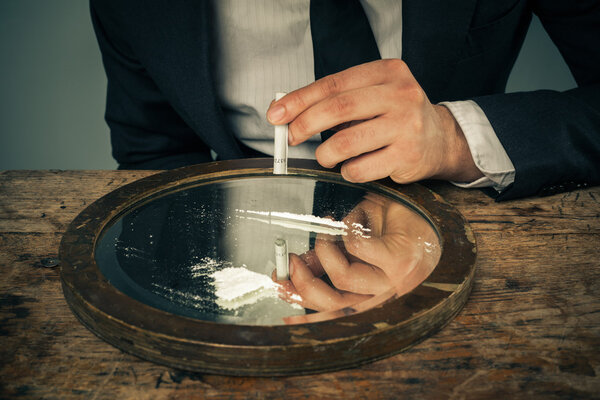Businessman snorting cocaine